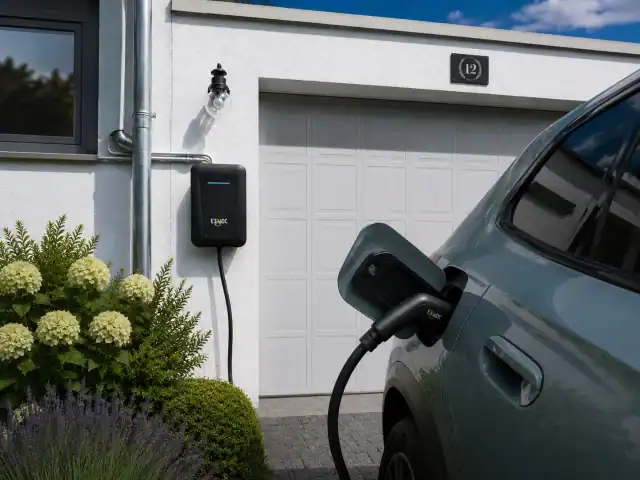 Elektroauto lädt an Wallbox vor Garage